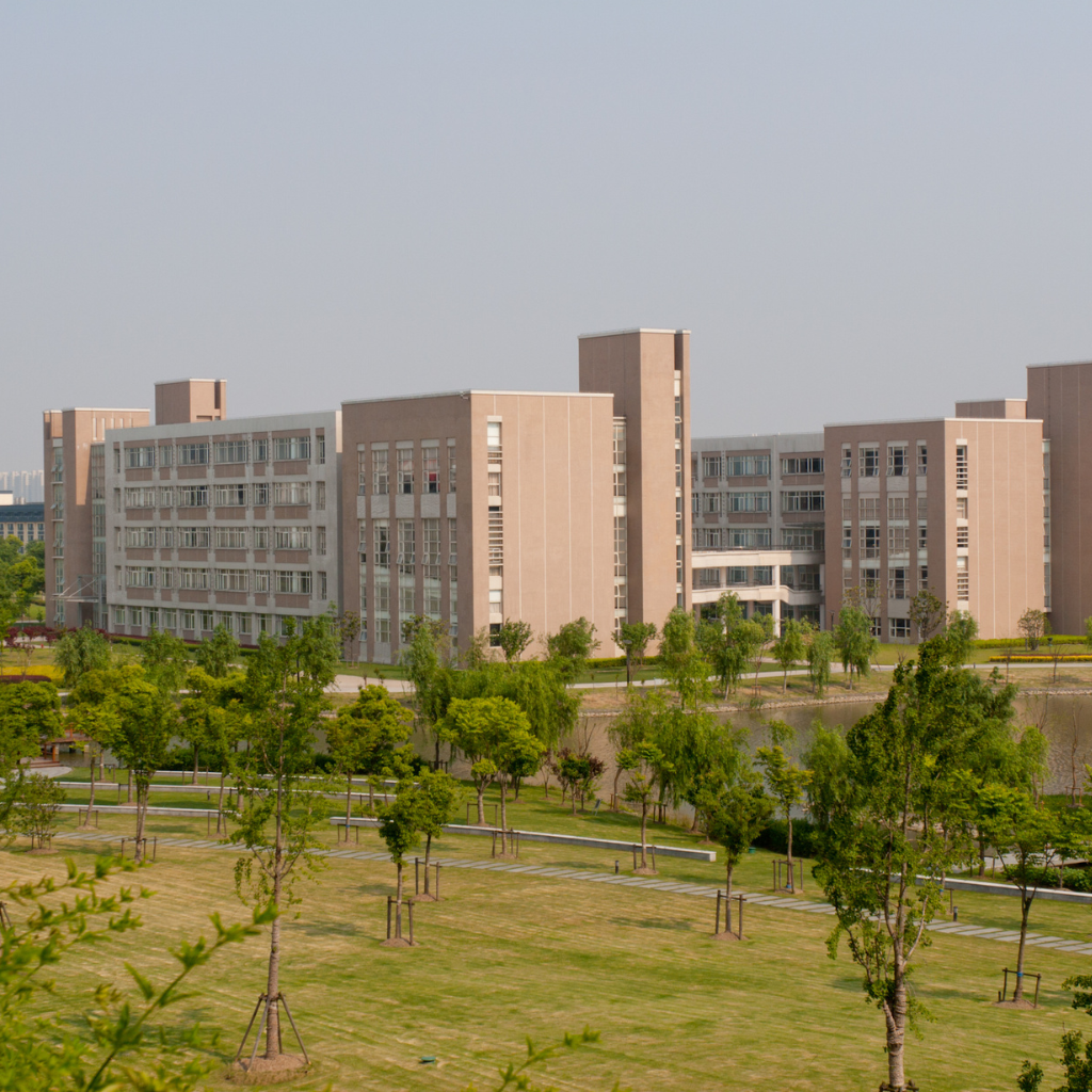 a brown colour building. with garden and trees